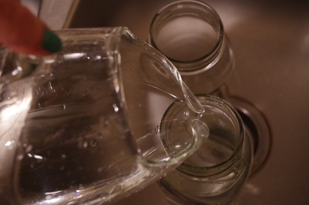 Once the water has boiled and then cooled back down to room temperature, you're back in snow globe business. Pour the water into your finest glass pitcher because this sh*t is going on the Internet and you don't want people to see how you live.  Now, pour the water from this fine glass pitcher into the Mason jars. It's probably a good idea to make sure you have enough water to fill the Mason jars, too.